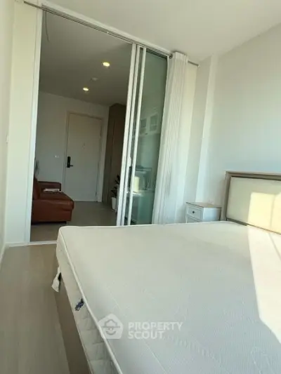 Modern bedroom with sliding glass doors and natural light