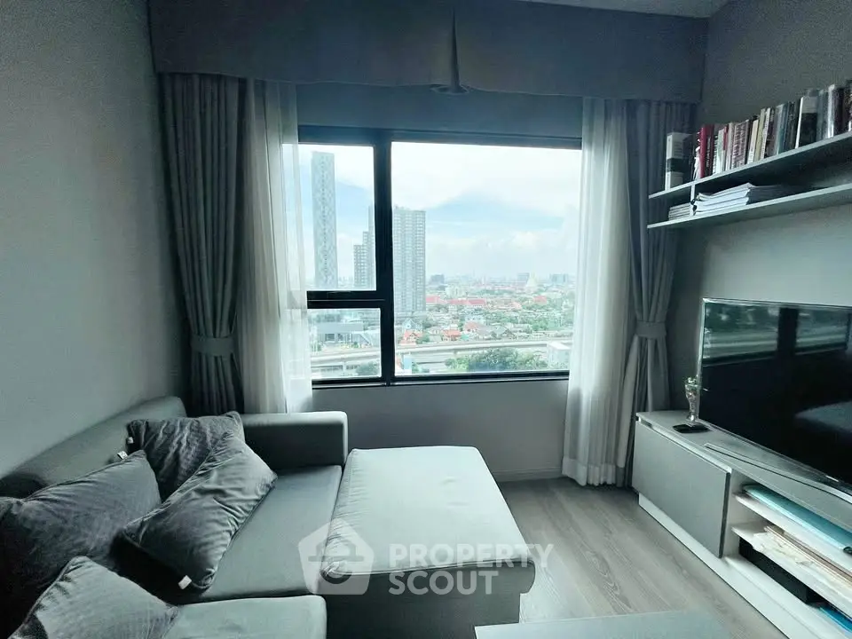 Modern living room with city view, cozy gray sofa, and sleek entertainment unit.