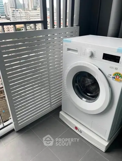 Modern balcony with washing machine and city view, perfect for urban living convenience.