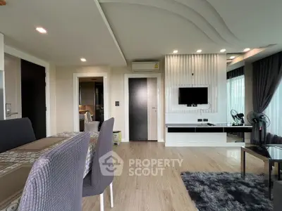 Modern living room with stylish decor and open layout, featuring sleek furniture and elegant lighting.