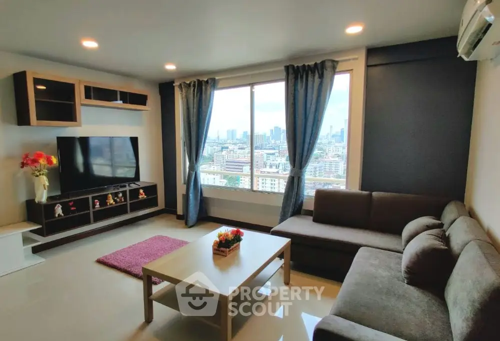Spacious living room with city view, modern furniture, and large window for natural light.