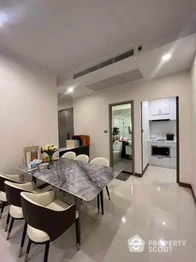 Modern dining area with marble table and elegant chairs in a stylish apartment