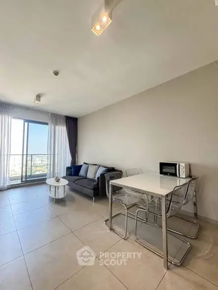 Modern living room with dining area and large windows offering a stunning view.