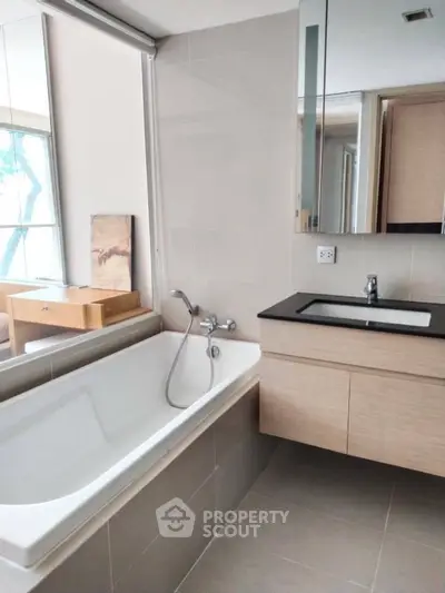 Modern bathroom with sleek design and large bathtub