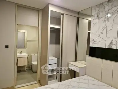 Modern bedroom with ensuite bathroom and stylish marble accents