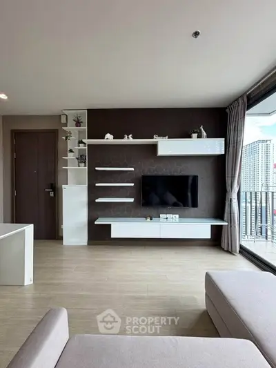 Modern living room with sleek TV unit and large balcony view
