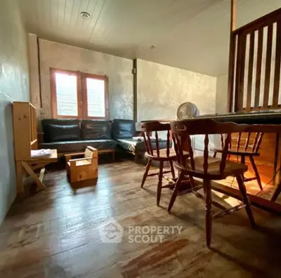 Cozy rustic living room with wooden furniture and natural light.