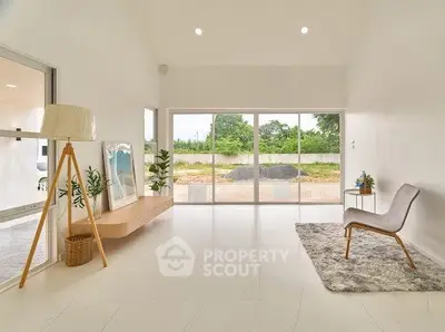 Spacious modern living room with large windows and minimalist decor