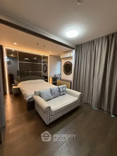 Luxurious bedroom with elegant decor and cozy seating area, perfect for relaxation and comfort.