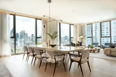 Luxurious open-plan living room with panoramic city views and elegant dining area.