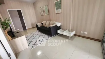 Spacious living room with modern decor and cozy sofa in stylish apartment.