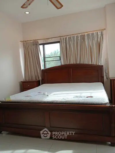 Cozy bedroom with wooden bed frame and natural light