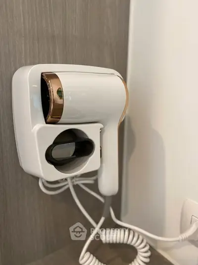 Modern wall-mounted hairdryer in a stylish bathroom setting.