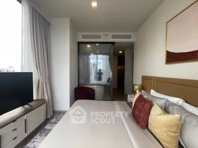 Luxurious bedroom with modern decor and city view, featuring a cozy bed and elegant furnishings.