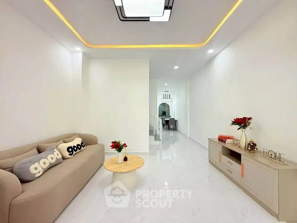 Modern living room with sleek design, cozy sofa, and elegant decor in a bright, spacious interior.