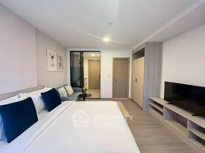 Modern bedroom with stylish decor and flat-screen TV, perfect for comfortable living.