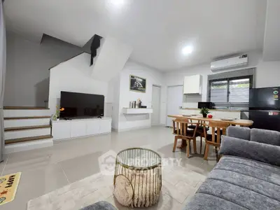 Modern open-plan living room with sleek kitchen and stylish decor