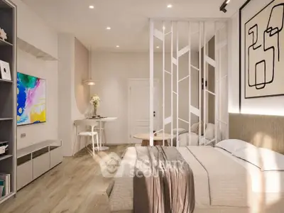 Modern bedroom with stylish decor and open layout, featuring a cozy bed and elegant partition.