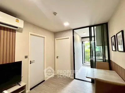Modern living room with sleek design and balcony view in a stylish apartment.