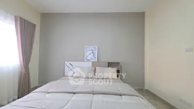 Modern bedroom with stylish decor and natural light, perfect for relaxation and comfort.