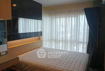 Cozy bedroom with large window and modern decor