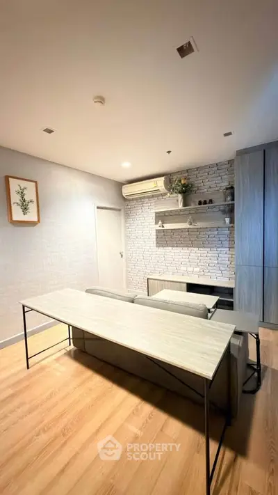 Modern living room with stylish decor and open layout, featuring a sleek table and cozy seating area.