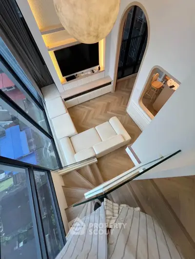 Stunning modern living room with floor-to-ceiling windows and elegant decor in a high-rise apartment.