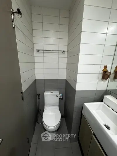 Compact modern bathroom with sleek fixtures and tiled walls, ideal for urban living spaces.