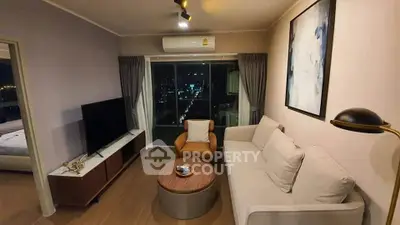 Modern living room with city view, stylish furniture, and elegant decor in a high-rise apartment.