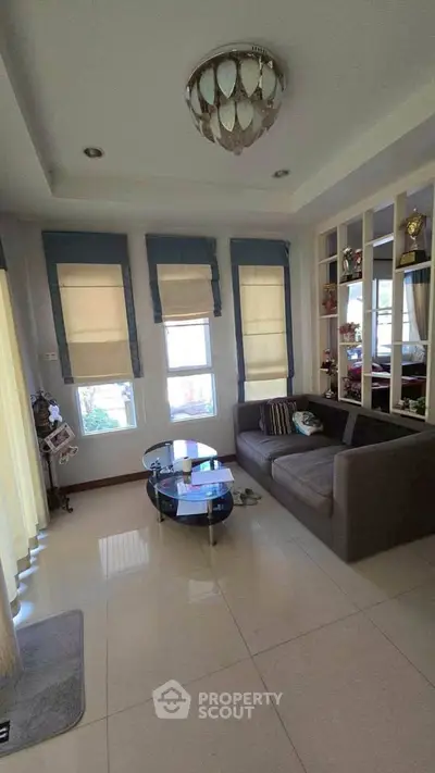 Charming living room with modern decor and ample natural light