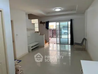 Spacious modern living room with large windows and sleek flooring