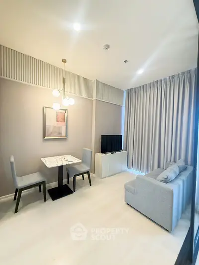 Modern living room with elegant decor, featuring a cozy sofa, dining table, and stylish lighting.