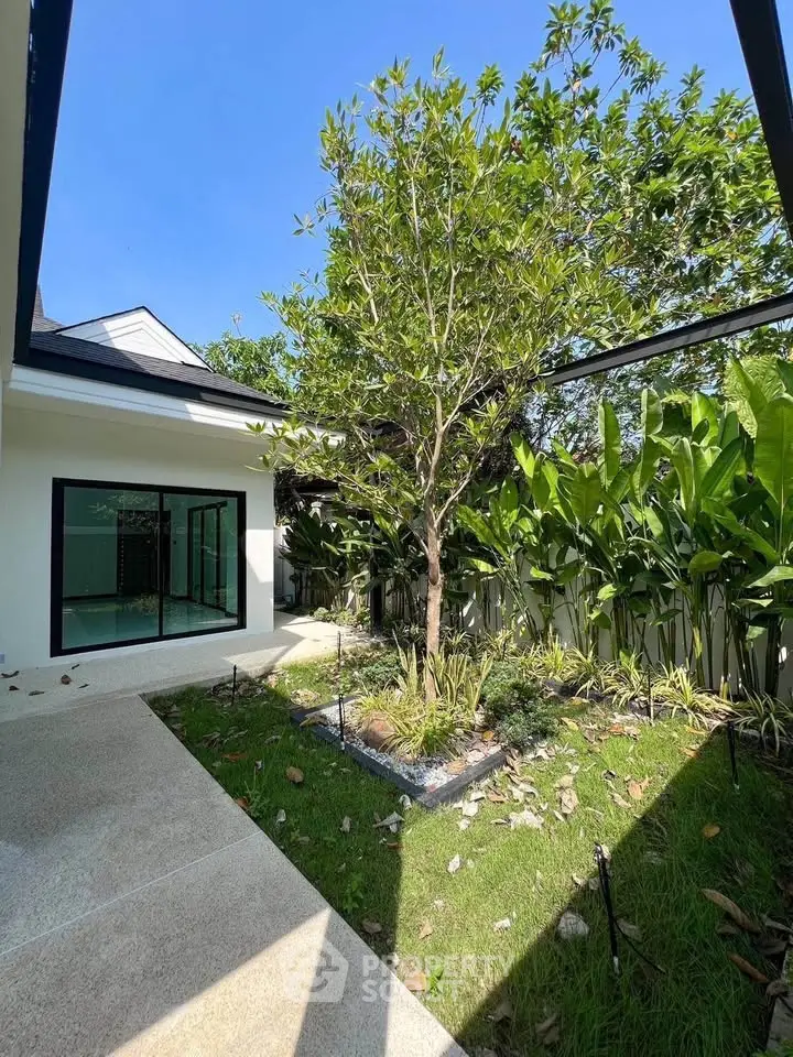 Charming garden view with lush greenery and modern architecture, perfect for serene living.
