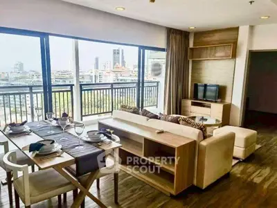 Spacious living room with city view and elegant dining area