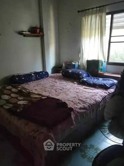 Cozy bedroom with natural light and simple decor