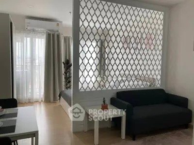 Modern open-plan living room with stylish partition and natural light