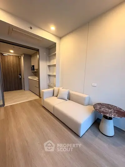 Modern living room with stylish sofa and marble side table in a cozy apartment.