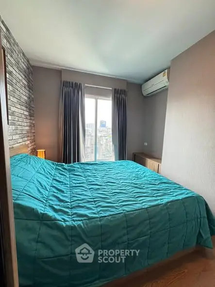Cozy bedroom with city view, featuring a comfortable bed and modern decor.