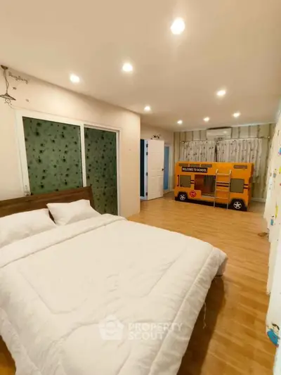 Spacious bedroom with modern decor and unique children's play area