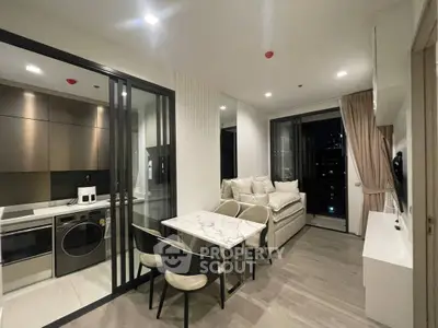 Modern open-plan living room with sleek kitchen and city view balcony.