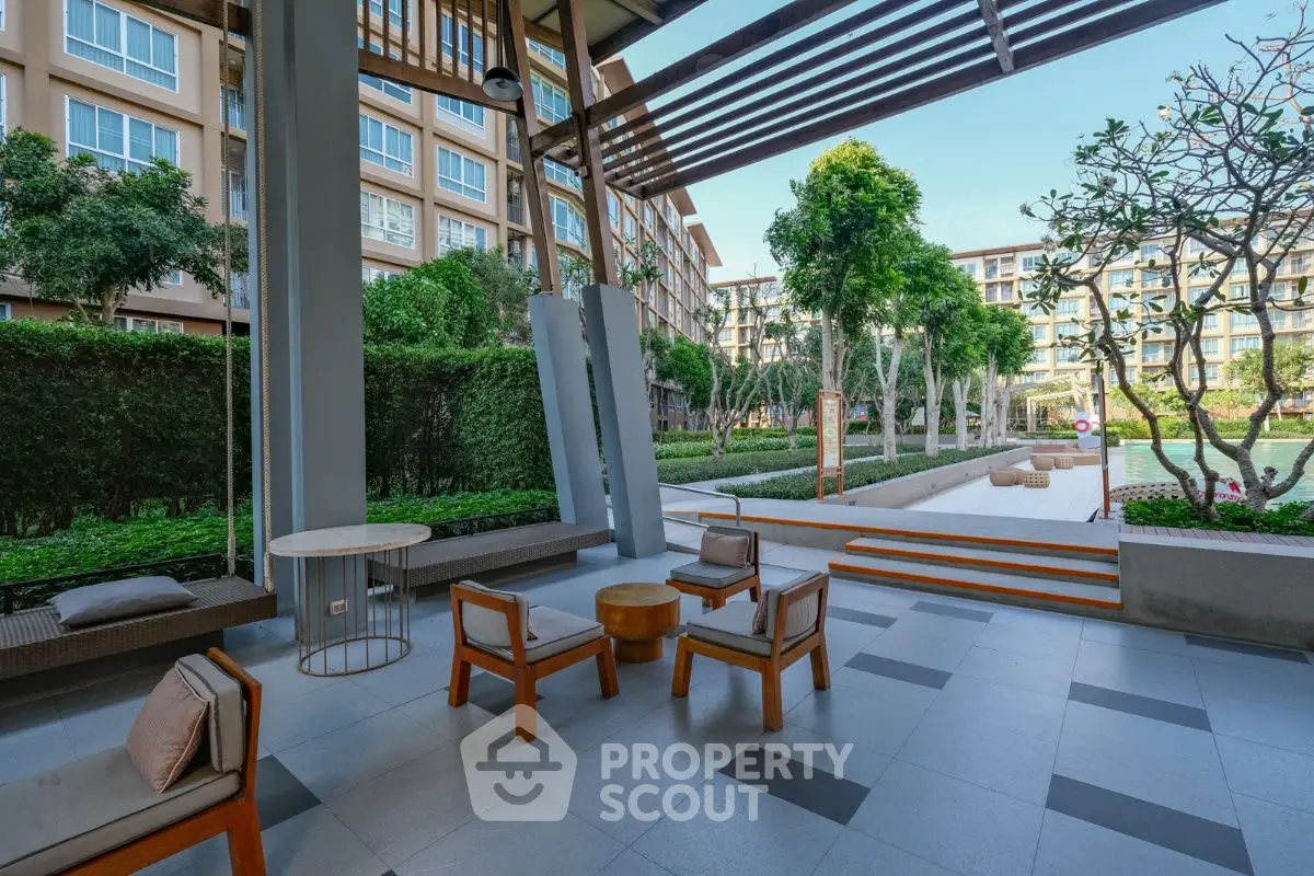 Modern apartment complex with stylish outdoor seating and lush greenery