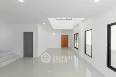 Spacious modern interior with sleek white walls and large windows