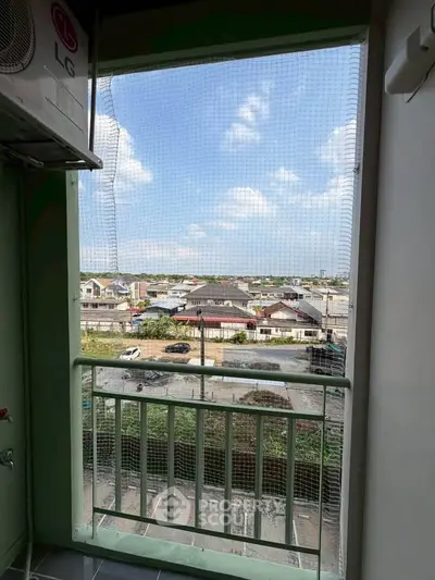 Charming balcony view overlooking suburban neighborhood with clear blue skies, perfect for relaxation.