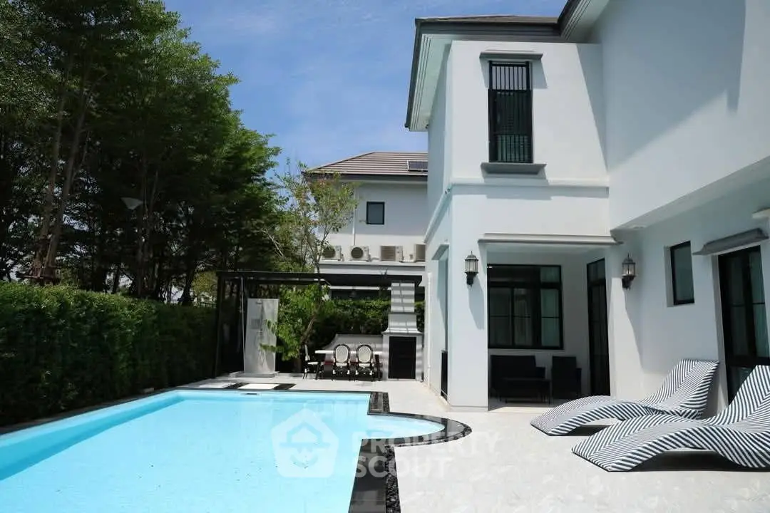 Luxurious modern villa with private pool and stylish outdoor seating area.