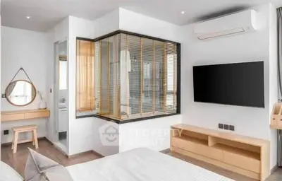 Modern bedroom with stylish decor, featuring a wall-mounted TV and air conditioning unit.