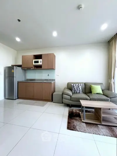 Modern open-layout living room with kitchenette and stylish furniture