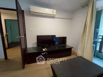 Cozy living room with air conditioning and modern TV setup