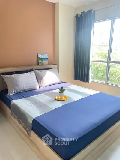Cozy bedroom with natural light and modern decor, featuring a comfortable bed and stylish curtains.