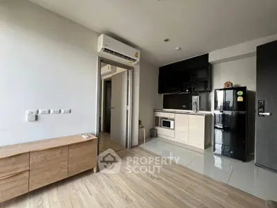 Modern apartment interior with sleek kitchen and wooden flooring