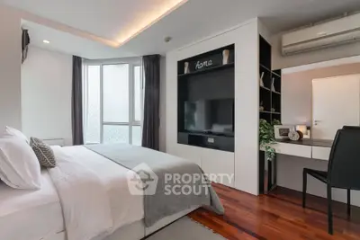 Modern bedroom with sleek design, featuring a cozy bed, built-in TV unit, and elegant decor.